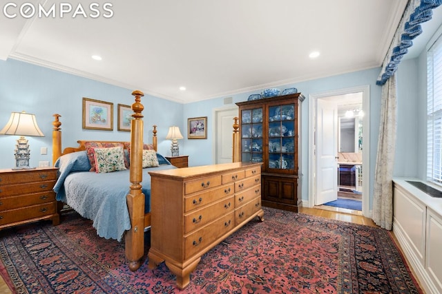 bedroom featuring crown molding, connected bathroom, and dark hardwood / wood-style flooring