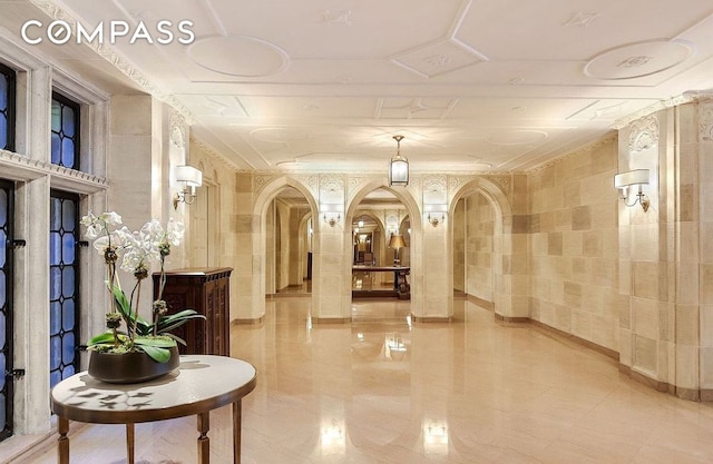 common area with crown molding and tile walls
