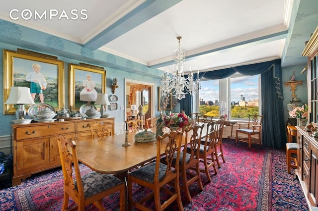 dining area featuring a chandelier, ornamental molding, and wallpapered walls
