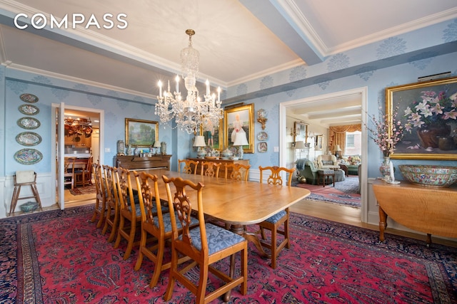 dining area with wallpapered walls, crown molding, a chandelier, and wood finished floors