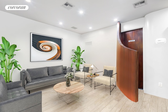 living area featuring recessed lighting, visible vents, and light wood-style floors