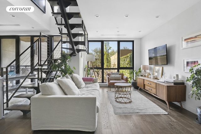 living room featuring stairway, wood finished floors, visible vents, recessed lighting, and expansive windows