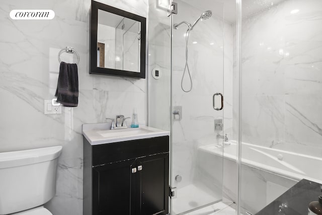 bathroom featuring vanity, a shower stall, tile walls, toilet, and marble finish floor