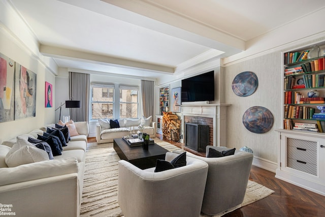 living area with a brick fireplace, baseboards, beamed ceiling, and ornamental molding