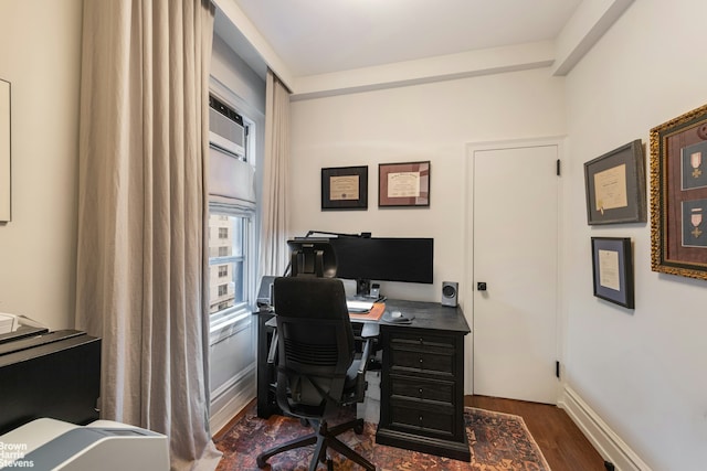 home office with dark wood-type flooring and baseboards