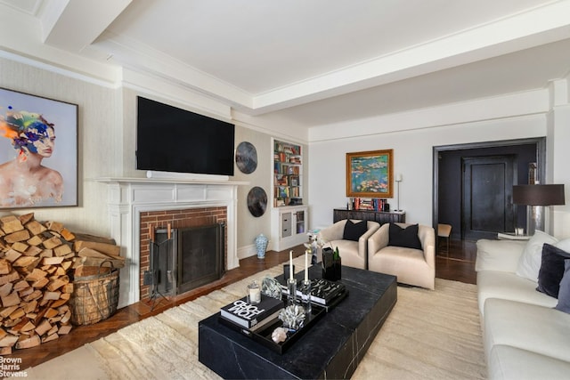 living room with a brick fireplace, crown molding, and light hardwood / wood-style flooring