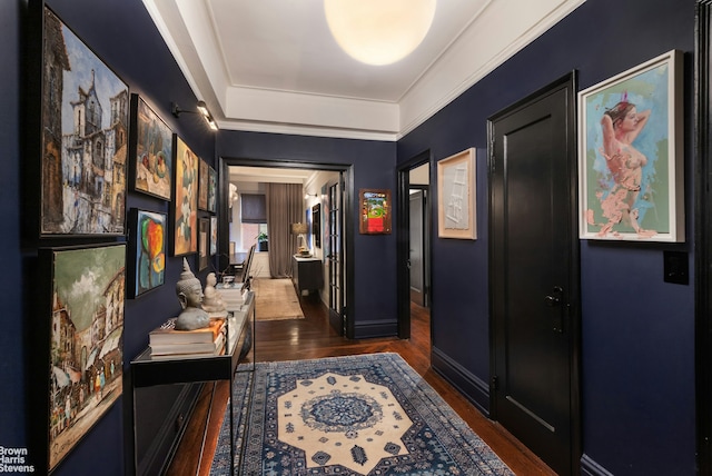 hall with baseboards and wood finished floors