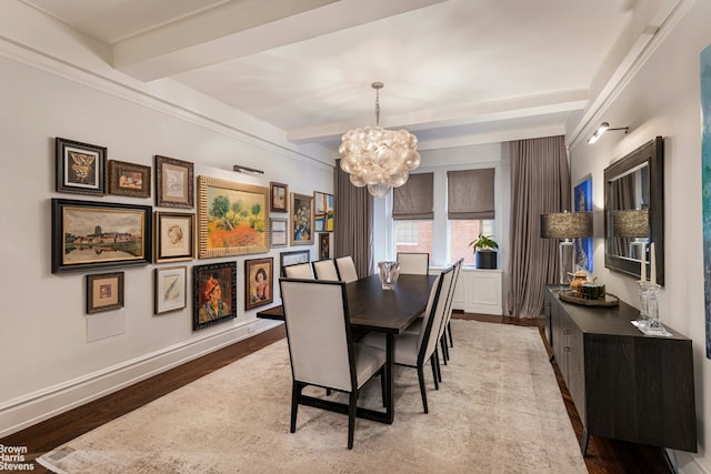 dining space featuring wood finished floors, a notable chandelier, and beamed ceiling