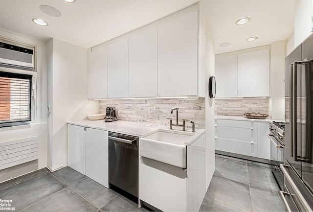 kitchen with stainless steel appliances, a sink, white cabinetry, decorative backsplash, and modern cabinets