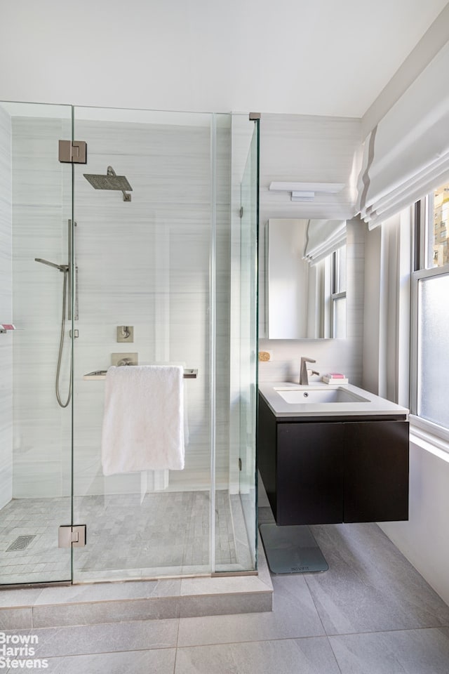 bathroom featuring a stall shower, tile patterned floors, and vanity