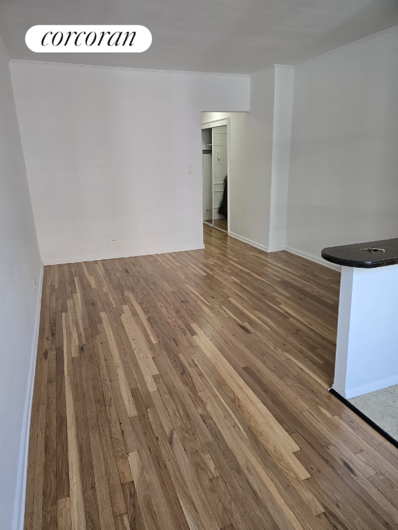 spare room with dark hardwood / wood-style flooring