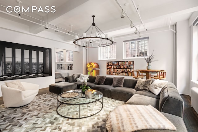241 W 36th St Unit 7R, New York City, NY 10018 - living area featuring rail lighting, wood finished floors, and a chandelier