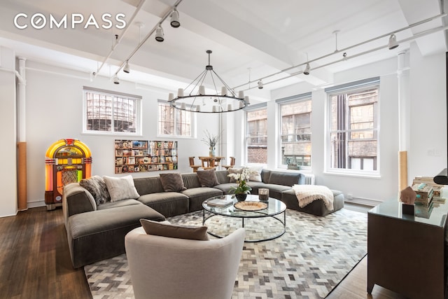 241 W 36th St Unit 7R, New York City, NY 10018 - living room with rail lighting, dark wood finished floors, and a chandelier