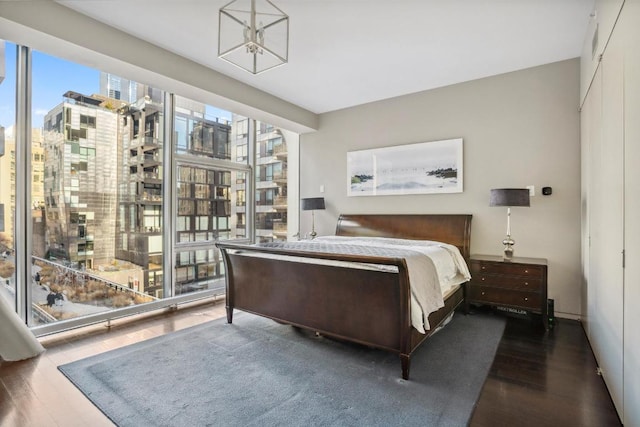 bedroom with dark hardwood / wood-style floors