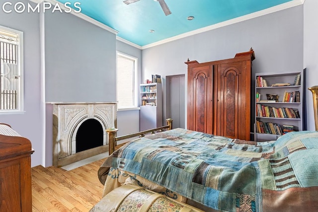 bedroom with crown molding, ceiling fan, and light wood-type flooring