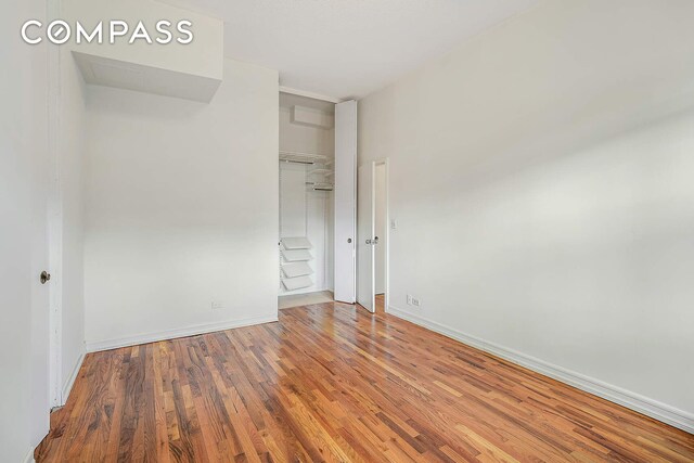 unfurnished bedroom featuring hardwood / wood-style flooring and a closet