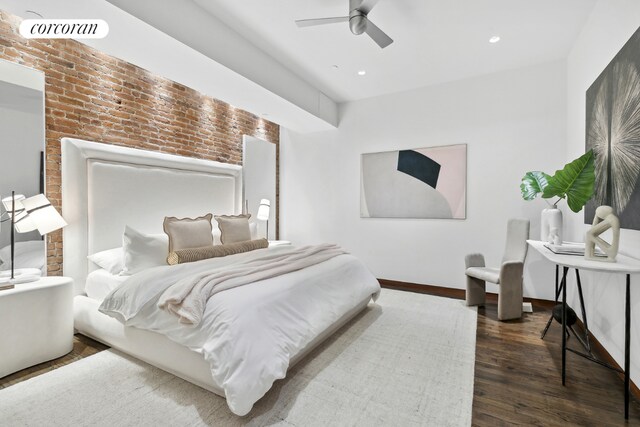 living room featuring a high ceiling, brick wall, and dark hardwood / wood-style flooring