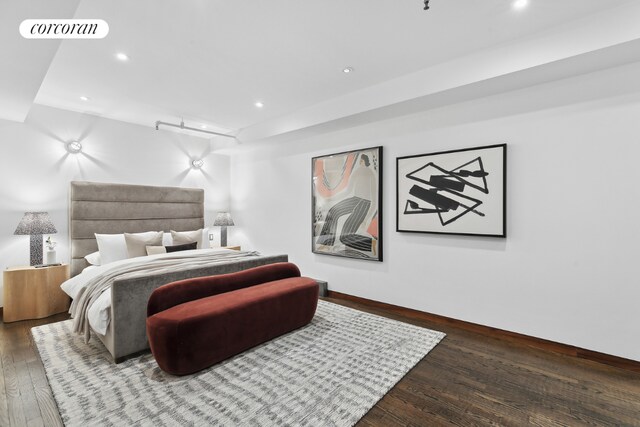 sitting room with brick wall and hardwood / wood-style floors