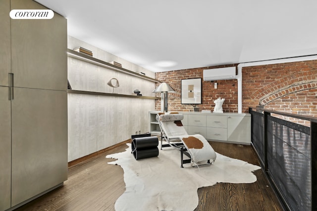 bathroom with wood-type flooring, brick wall, and an AC wall unit