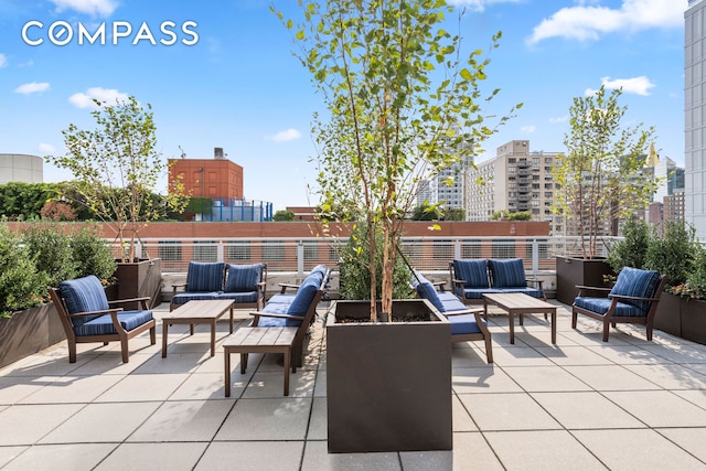 view of patio / terrace featuring a city view and an outdoor hangout area