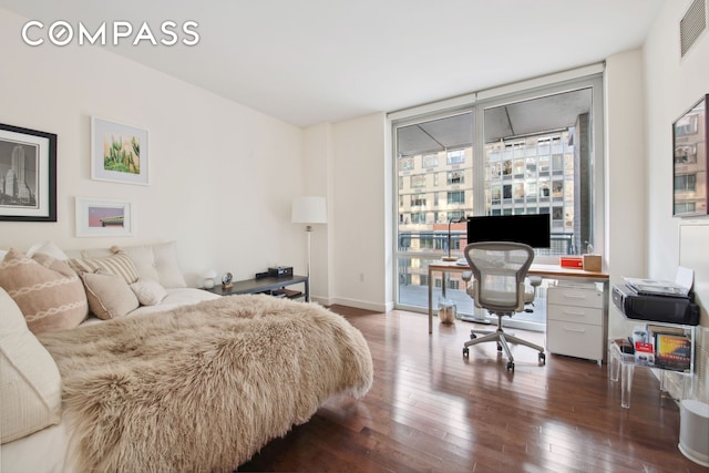 bedroom featuring access to exterior, multiple windows, a wall of windows, and hardwood / wood-style floors