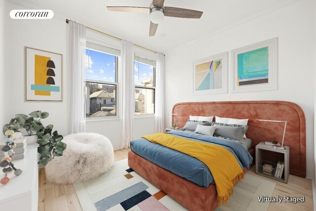 bedroom featuring wood finished floors, visible vents, and ceiling fan