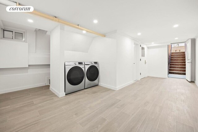 washroom with laundry area, wood finished floors, washer and dryer, and recessed lighting