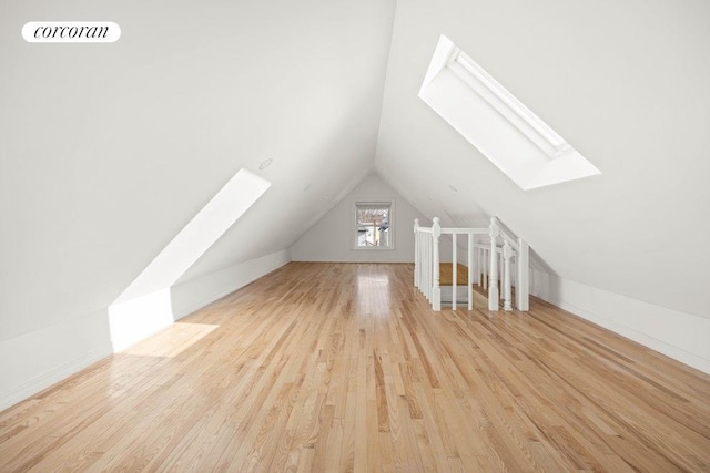 1542 E 22nd St, New York City, NY 11210 - additional living space featuring a skylight, lofted ceiling, and wood finished floors