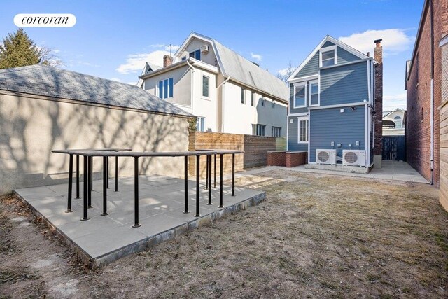 rear view of house with a fenced backyard, a chimney, and a patio