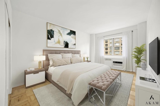 bedroom featuring light parquet flooring and a wall unit AC