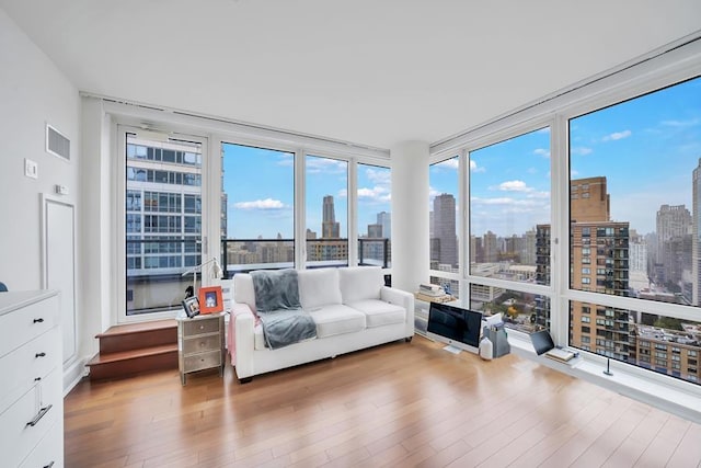 sunroom / solarium featuring a skyline view