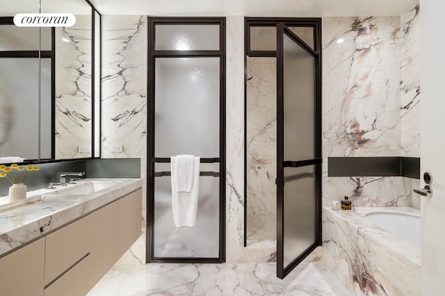 bathroom featuring vanity and independent shower and bath