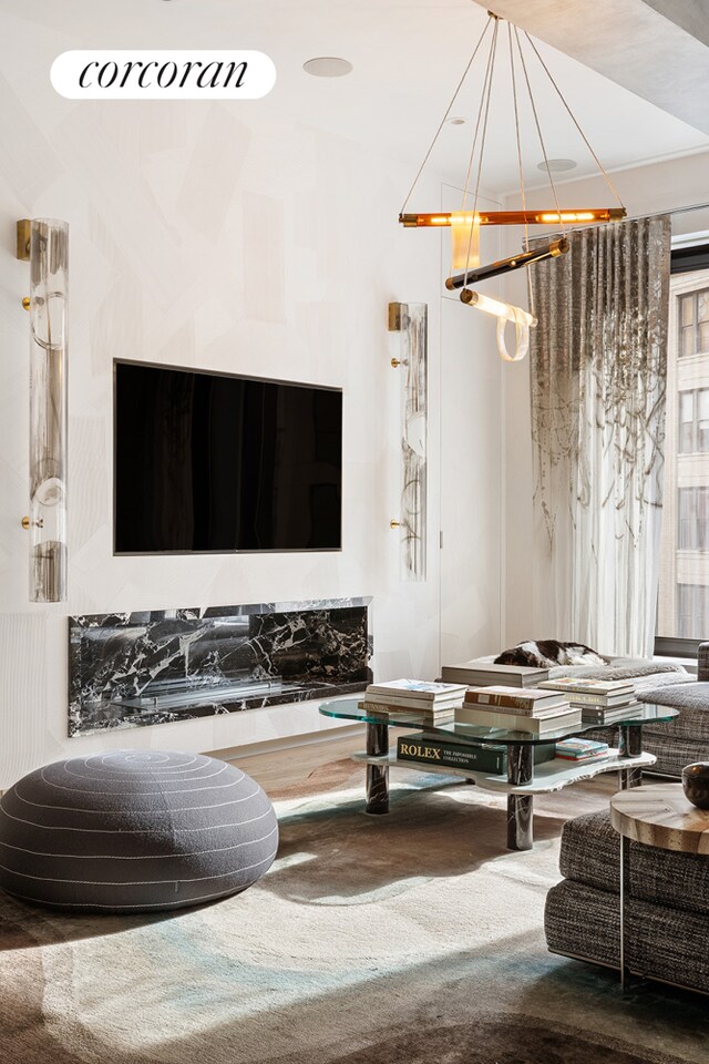 dining area featuring a healthy amount of sunlight, sink, light hardwood / wood-style floors, and beamed ceiling