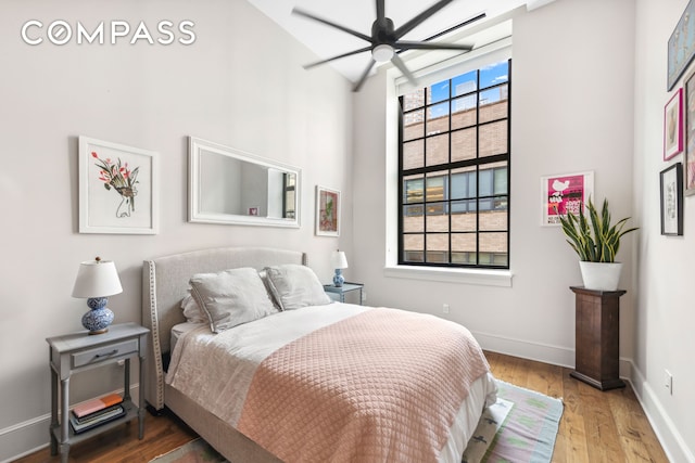 520 W 45th St Unit 4D, New York City, NY 10036 - bedroom featuring a high ceiling, wood finished floors, and baseboards