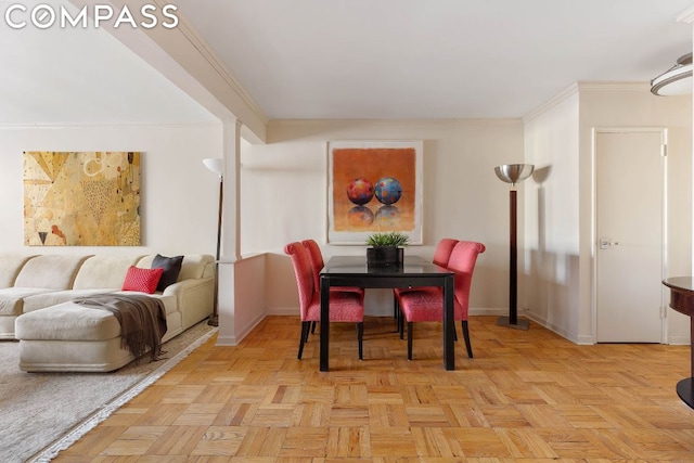 dining room featuring light parquet flooring and ornamental molding