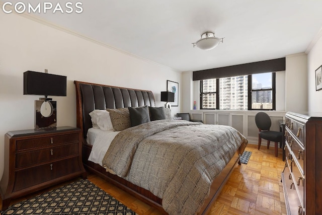 bedroom featuring crown molding and light parquet flooring