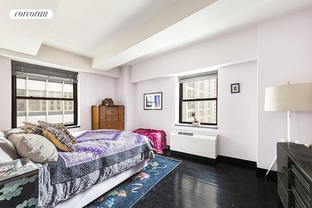 bedroom with baseboards, multiple windows, dark wood-type flooring, and visible vents