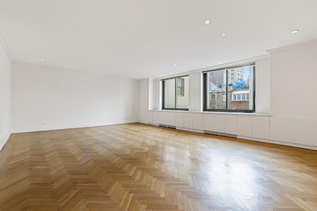 unfurnished room with ornamental molding and light parquet flooring