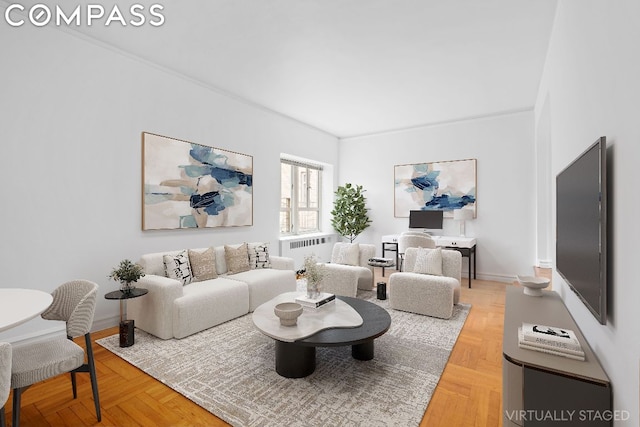 living room featuring ornamental molding, parquet flooring, and radiator heating unit