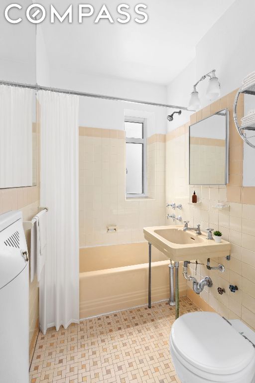 bathroom with shower / tub combo and toilet