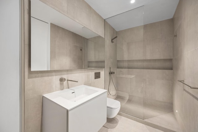 bathroom with toilet, vanity, tile walls, tile patterned floors, and walk in shower