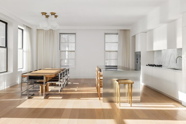 dining space with light wood-style flooring