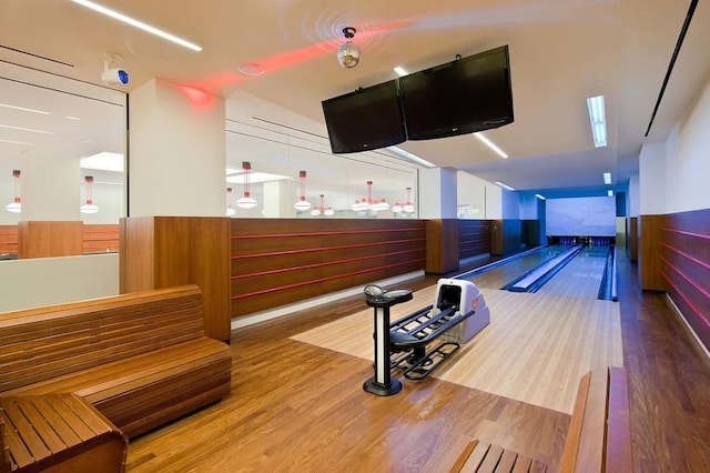 50 Riverside Blvd Unit 11J, New York City, NY 10069 - rec room featuring a bowling alley, wood finished floors, a wainscoted wall, and wood walls