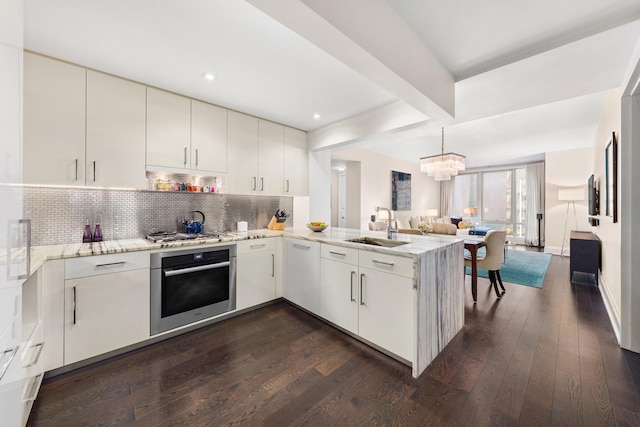 50 Riverside Blvd Unit 11J, New York City, NY 10069 - kitchen with a sink, a peninsula, tasteful backsplash, appliances with stainless steel finishes, and open floor plan