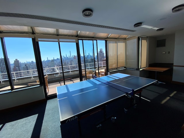 rec room featuring a view of city and visible vents