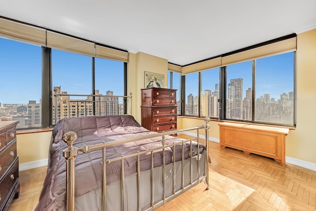 bedroom featuring baseboards, a city view, and crown molding