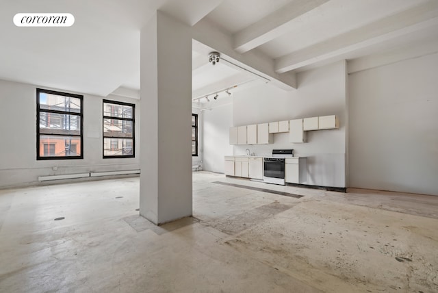 unfurnished living room featuring sink, beam ceiling, track lighting, and high vaulted ceiling