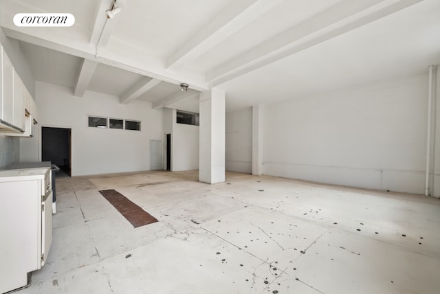 unfurnished living room with beamed ceiling