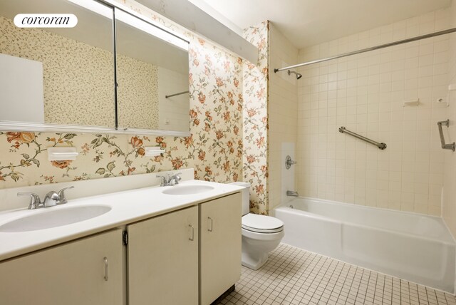 full bathroom featuring tile patterned flooring, tiled shower / bath, vanity, and toilet