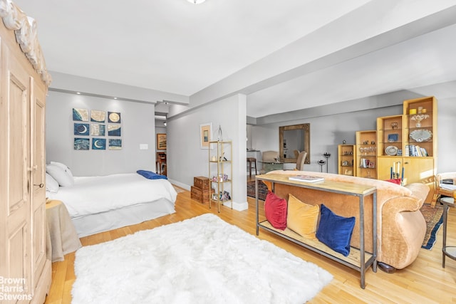 bedroom with light wood-style flooring and baseboards